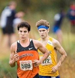 Cross-country race with two runners; Dr. Bourke is the runner on the right in a yellow University of Delaware singlet, bib 372, racing alongside a Princeton runner